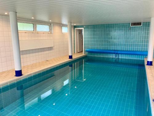 an empty swimming pool with blue tile walls and blue tiles at Duene 30 in Wangerooge