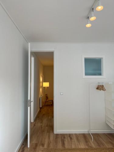 a hallway with white walls and a white door at Braga Centro, Totalmente remodelado em 2023! in Braga