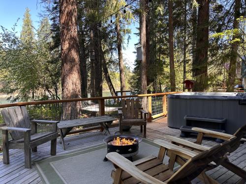 a deck with benches and a fire pit at Jack's Cabin by NW Comfy Cabins in Leavenworth