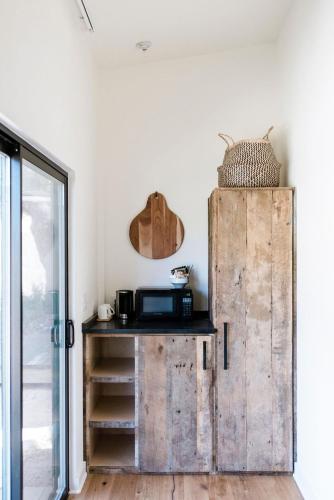 a room with a wooden cabinet next to a door at Contigo Ranch Fredericksburg in Fredericksburg