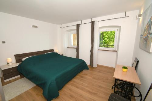 Posteľ alebo postele v izbe v ubytovaní Apartmani Donata