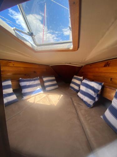 a room with pillows and a window in a boat at Boat Barcelona Yacht in Barcelona