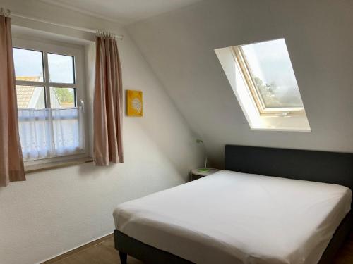ヴァンガーオーゲにあるHaus Arnoldのベッドルーム(白いベッド1台、窓付)