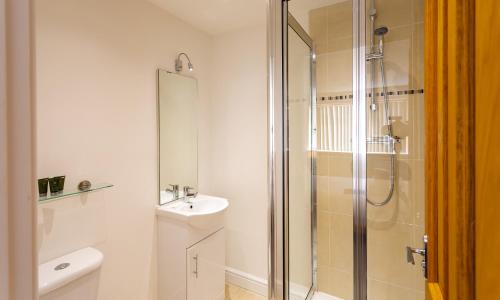 a bathroom with a shower and a sink at Tewitfield Marina in Carnforth