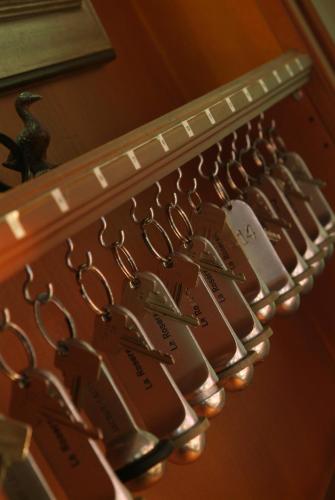 a bunch of keys hanging on a rack at La Roseraie. Gaume-Ardenne-lacuisine sur Semois. in Florenville