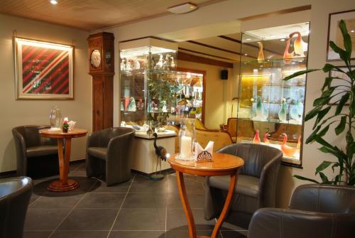 a waiting room with chairs and tables in a restaurant at La Roseraie. Gaume-Ardenne-lacuisine sur Semois. in Florenville