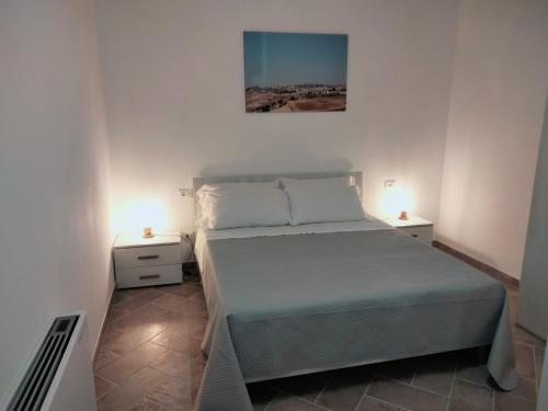 a bedroom with a bed and two night stands at LA TERRAZZA in Ioppolo Giancaxio