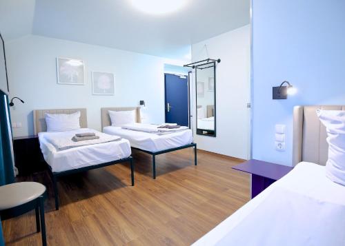 a hospital room with two beds and a mirror at Das Schreder Hotel in Munich