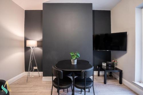 a black dining room with a black table and chairs at Trent House TSAC in Stockton-on-Tees