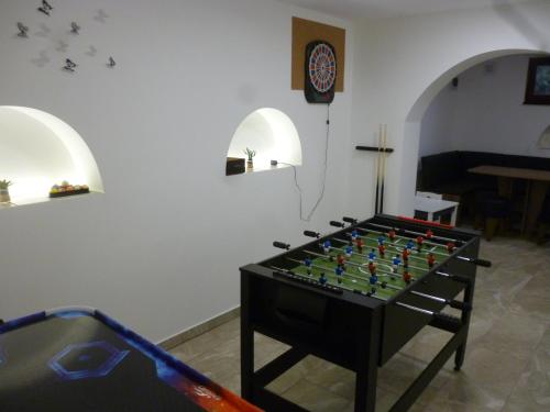 a foosball table in the middle of a room at Vincellér Vendégház in Királyszentistván