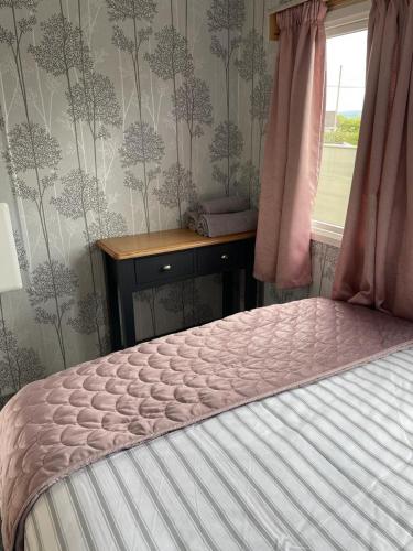 a bedroom with a bed and a desk and a window at The Rock Bar B&B in Kilkenny