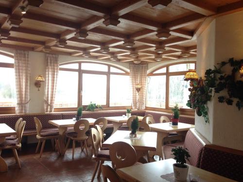 a restaurant with tables and chairs and windows at Alte Rose Gasthaus in Ebelsbach
