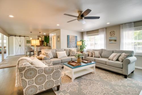 a living room with a couch and a table at Charming Mountain Home Retreat Walk to Marina! in Mountain Home