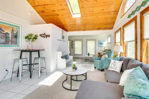 a living room with a couch and a table at Charming Mountain Home Retreat Walk to Marina! in Mountain Home