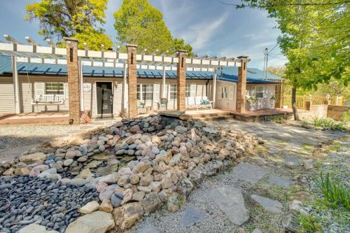 a stone fire pit in front of a house at Charming Mountain Home Retreat Walk to Marina! in Mountain Home