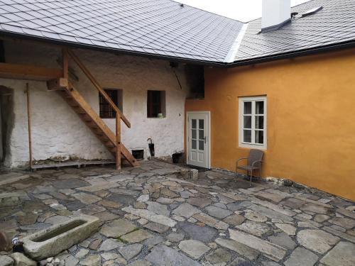 a house with a stone patio in front of it at Měšťanský dům Rožmberk 31 in Rožmberk nad Vltavou