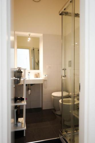 a bathroom with a toilet and a sink and a shower at I'MC IoAMoCagliari in Cagliari