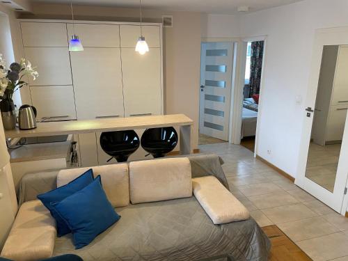 a living room with a couch and a table at ComeWa Apartments in Warsaw