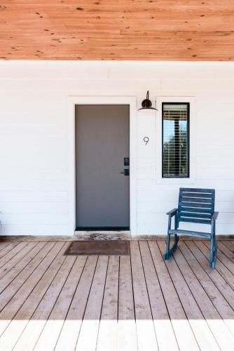 a blue bench sitting on the porch of a house at Contigo Ranch Fredericksburg in Fredericksburg