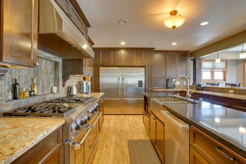 a large kitchen with wooden cabinets and stainless steel appliances at Expansive Retreat on 5 Acres in Shakopee! in Shakopee