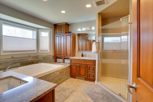 a bathroom with a tub and a sink and a shower at Expansive Retreat on 5 Acres in Shakopee! in Shakopee