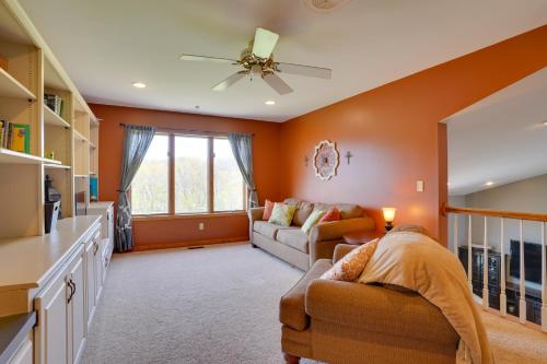 a living room with a couch and a ceiling fan at Expansive Retreat on 5 Acres in Shakopee! in Shakopee