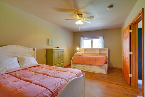 a bedroom with two beds and a ceiling fan at Expansive Retreat on 5 Acres in Shakopee! in Shakopee