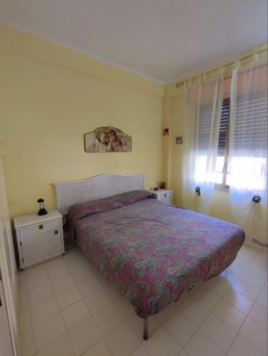 a bedroom with a bed with a purple bedspread at Licia Comfort Zone in Sciacca
