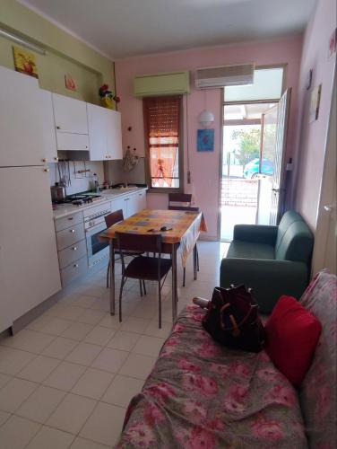 a kitchen with a table and a couch in a room at Licia Comfort Zone in Sciacca