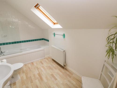 a bathroom with a toilet and a sink and a bath tub at Ty Rhosyn in Haverfordwest