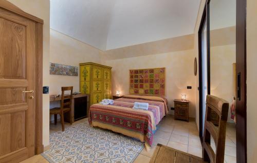 a bedroom with a bed and a desk in it at Angolo Arancio Bed & Breakfast in San Vito lo Capo