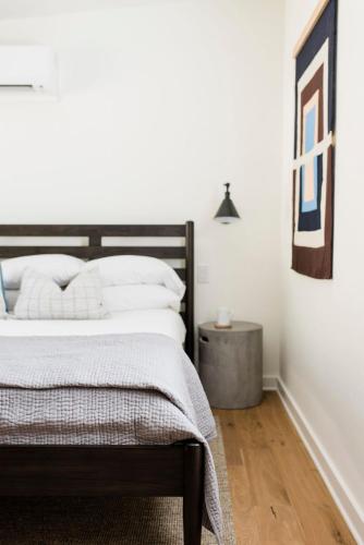 a bedroom with a bed and a side table at Contigo Ranch Fredericksburg in Fredericksburg