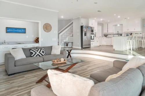 a living room with a couch and a table at Sandy Feet Retreat in Panama City Beach