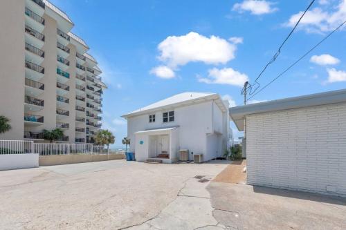 a white building next to a apartment building at Sandy Feet Retreat in Panama City Beach