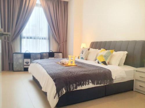 a bedroom with a large bed with a tray on it at Arcoris SOHO Mont Kiara in Kuala Lumpur