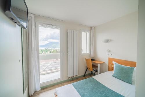 a hotel room with a bed and a window at Centre Jean XXIII in Annecy