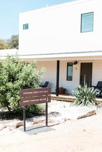 a sign in the sand in front of a house at Contigo Ranch Fredericksburg in Fredericksburg