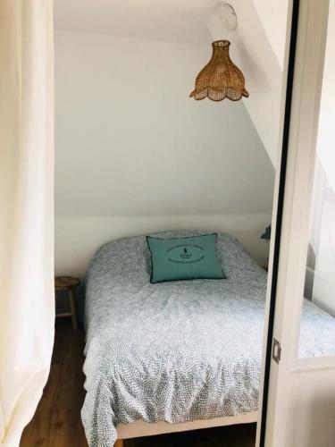 - une petite chambre avec un oreiller vert sur un lit dans l'établissement Quiet apartment with sea view, à Villers-sur-Mer