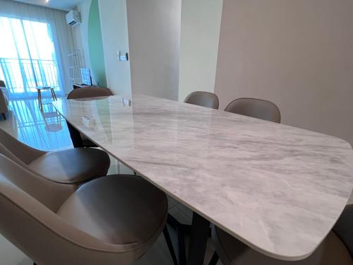 a conference room with a large marble table and chairs at METROPOL SERVICED APARTMENT at Bukit Mertajam, Pulau Pinang in Bukit Mertajam