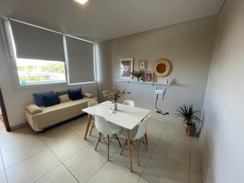 a living room with a table and a couch at Andes Apartments Bandera in Mendoza