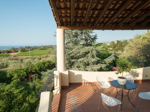 a patio with a table and chairs and a view at B&B Don Gaspano in Milazzo