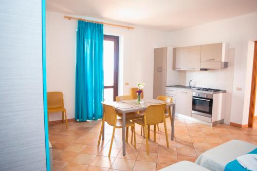 a kitchen and dining room with a table and chairs at Resort Santa Maria Hotel in Birgi Vecchi