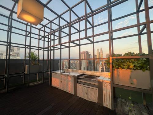 a rooftop kitchen with a view of the city at Anggun KL Malaysia in Kuala Lumpur