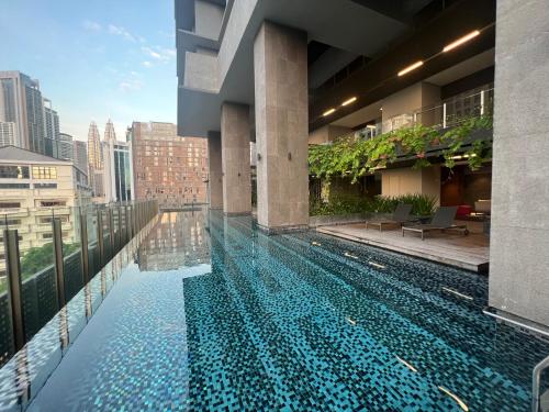 a swimming pool on the roof of a building at Anggun KL Malaysia in Kuala Lumpur