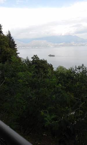 a view of the ocean with a boat in the water at Residenza del Pascià - Appartamento Camphora in Oggebbio