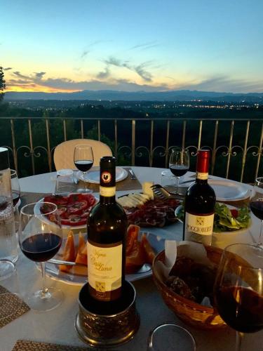 two bottles of wine sitting on a table with wine glasses at Agriturismo Bellavista in San Miniato