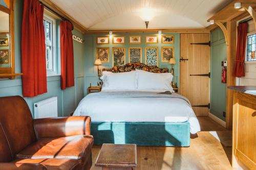 a bedroom with a bed and a couch at Hornington Manor Luxury Shepherd Huts in York