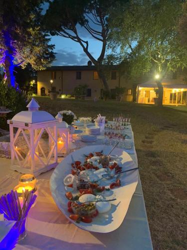 a long table with plates of food on it at Agriturismo Bellavista in San Miniato