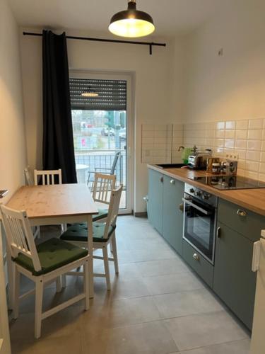 a kitchen with a table and a table and chairs at Pension Altes Forstamt in Eberswalde