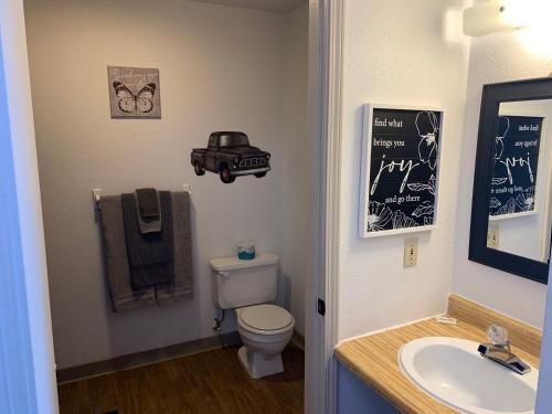 a bathroom with a toilet and a sink and a chalkboard at Brownsville Motel in Brownsville